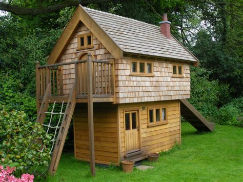 While the kids are having a fun time playing inside the playhouse, the parents can sit on a comfy bench with seat cushions. Walnut Cottage Children's Playhouse | Flights of Fantasy