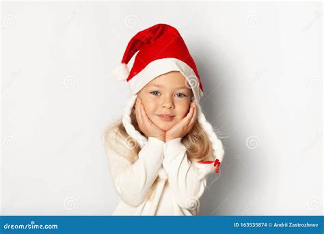 Portrait Of Little Pretty Little Girl In Santa Hat Isolated On White