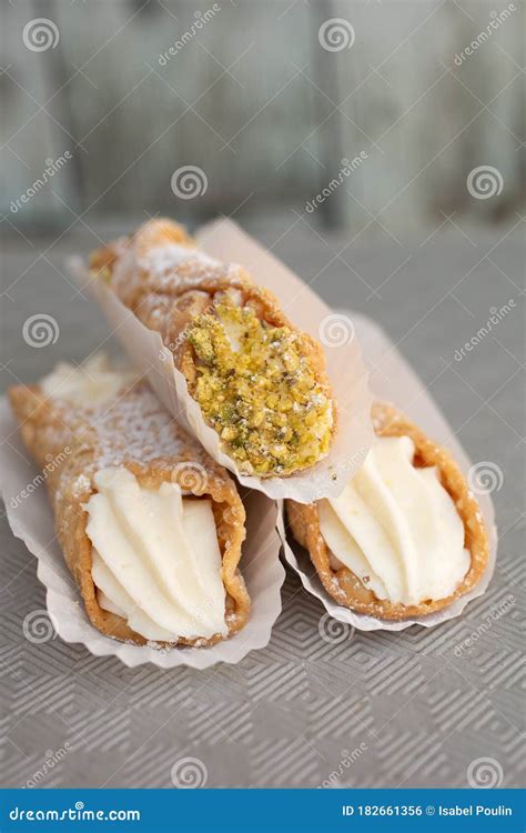 Top View Of Four Delicious Cannoli On Wooden Background Stock Photo