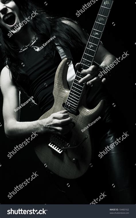 Man With Long Hair Playing Electrical Guitarblack And
