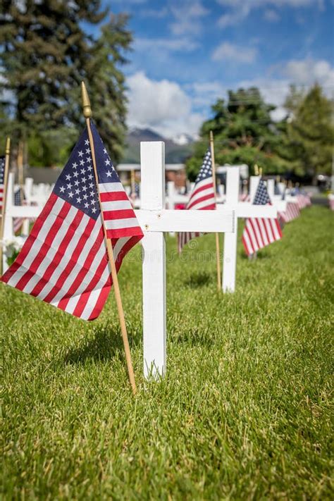 Military Grave Markers Decorated With American Flags For Memorial Day