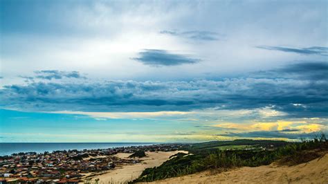 Download 5120x2880 Wallpaper Sand Landscape Coast City Clouds Sky