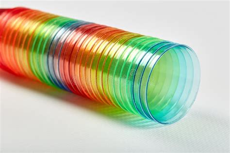 Many Multi Colored Rainbow Colored Plastic Glasses Are Stacked Together