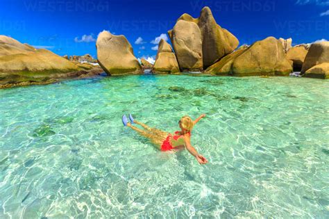 Happy Woman In Bikini Lying In Turquoise Water In The Natural Pool Of