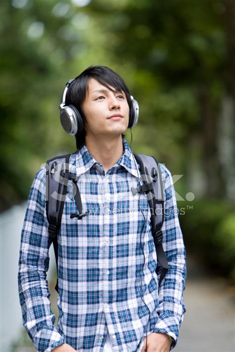 Man With Headphones Walking Along Sidewalk Stock Photo Royalty Free
