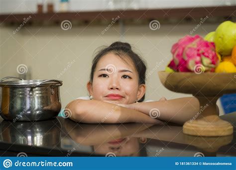 Beautiful Overwhelmed And Stressed Korean Girl Working In Kitchen