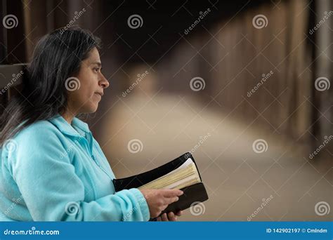 hispanic woman reading bible on bridge stock image image of female people 142902197