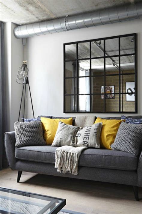 A Gray Industrial Living Room With A Gray Sofa And Yellow