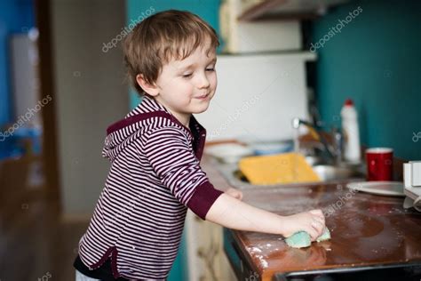 Boy Cleaning The Kitchen — Stock Photo © Djedzura 23580877