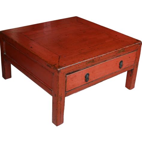 Peruvian artisan carries on the artisanal traditions of her country, giving this ottoman/coffee table tray a floral design that is painted by hand onto the reverse side of a rectangular glass panel. Chinese Red Coffee Table with Drawer