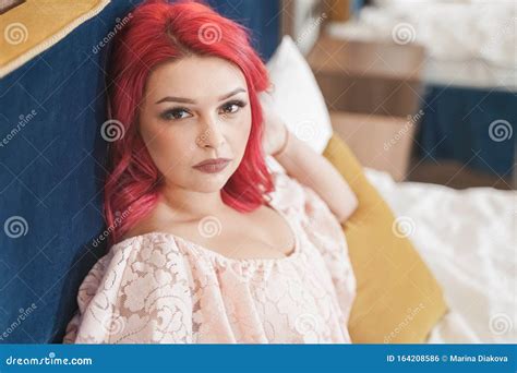 Portrait Of Beautiful Alluring Young Woman In Pink Lingerie Lying In