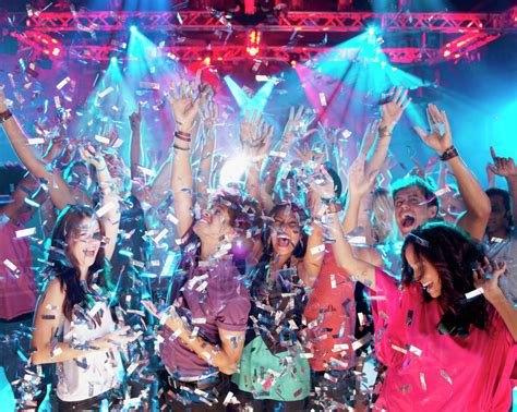 Confetti Falling Over Enthusiastic Crowd On Dance Floor Of Nightclub