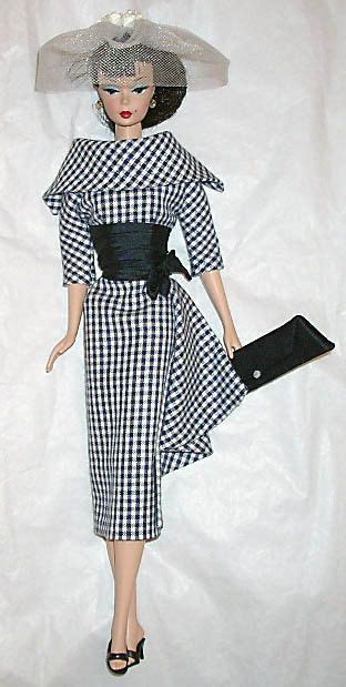 A Barbie Doll Wearing A Black And White Checkered Dress With Matching