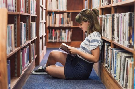 Girl Reading In Library Free Photo