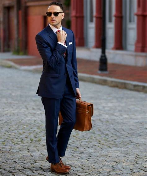 Crisp slim navy suit with brown cap toe shoes brown leather belt light blue shirt white cotton pocket square lapel pin #businesscasual #suit however, when done right, a blue suit and brown shoe combination can look just as sharp and even more sartorial than any suit and black shoe ensemble. Pin on Wedding