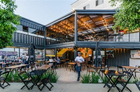 Urban Shipping Container Restaurant With A Beautiful Wooden Pergola