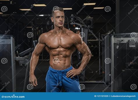 A Young Handsome Male Athlete Bodybuilder Posing In Front O Stock Image