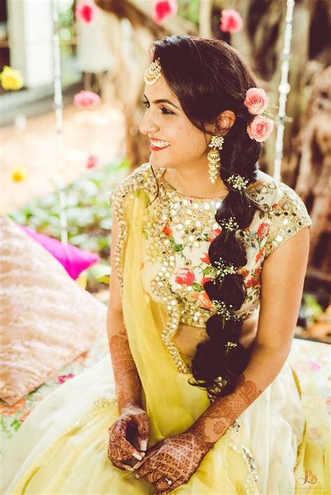 A thick long braid decorated with flower garlands pearls or chic golden accessories is considered to be a traditional hairstyle variety for the indian style wedding. Stunning braided ponytail for mehendi function. See more ...