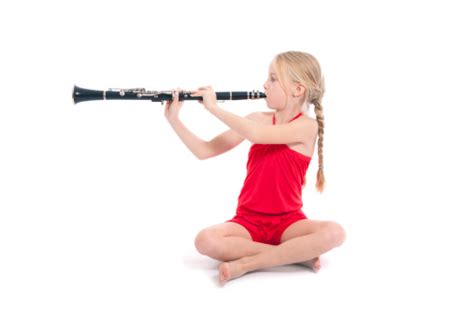 Young Sitting Girl In Red Playing Clarinet Stock Photo Download Image