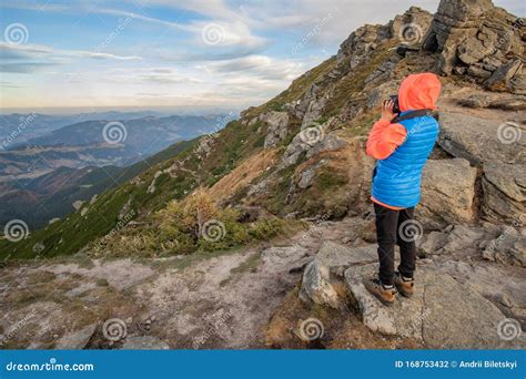 Young Child Boy Hiker Taking Pictures In Mountains Enjoying View Of