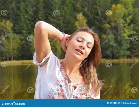 Beautiful Young Woman Relaxing Near A Lake Stock Photo Image Of