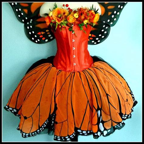 A Dress Made To Look Like A Butterfly With Flowers On Its Head And Wings