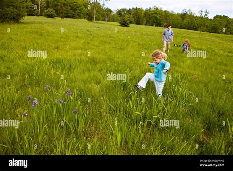 A Young Girl Age 4 Leads The Way In A Field At Highland Farm In York