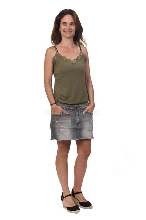 Woman In A Denim Skirt On White Background Side View And Arms Crossed