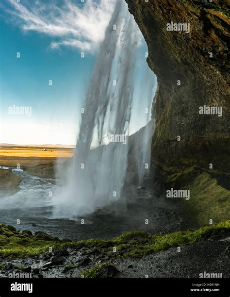 Cave Behind Seljalandsfoss Waterfall In Iceland With Long Exposu Stock
