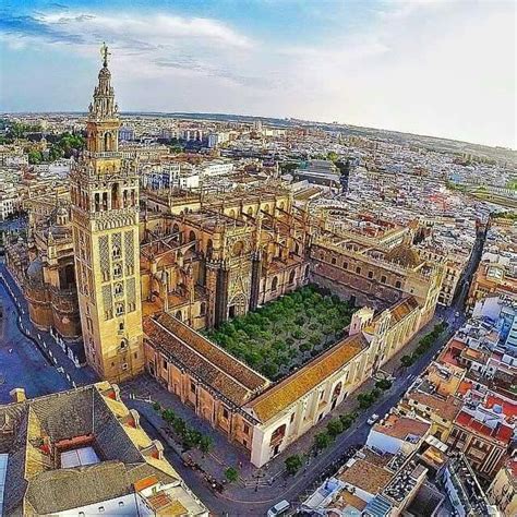 Seville Catedral With La Giralda Its Belltower And Patio De Los