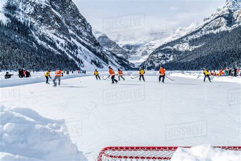 A Pair Of Hockey Teams Compete In Pond Hockey On Lake Louise At The