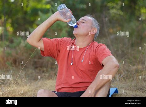 Man Drinking Water Bottle In A Park Stock Photo Alamy