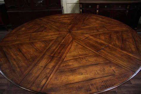 Round rustic dining table with walnut finish and robust base. Jupe Table | Extra Large Round Solid Walnut Round Dining Table