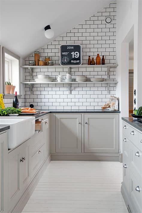 The focal wall in this kitchen features open shelving, subway tile, and stainless appliances. decordots: 2014 August