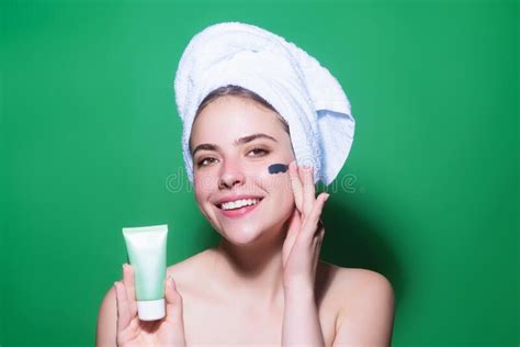 Beautiful Model Applying Cosmetic Cream Treatment On Face Facial
