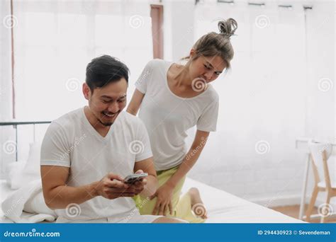 Funny Couple Wife Peeking Husband Who Chatting On The Smartphone