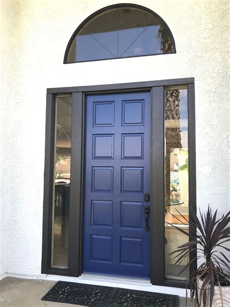 As a primary design element, the bold color scheme, comprised of white with splashes of blue the kitchen islands are chalk tone navy, and the cabinets are wood tone with glass fronts and backs. White House Blue Front Door Brown Trim. Dunn Edwards Jazz ...