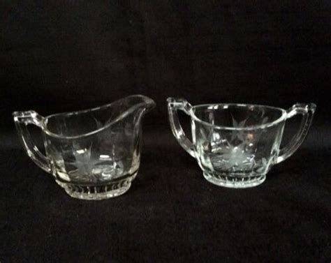 Old creamer & sugar beautifully etched floral pattern. ETCHED FLORAL CLEAR GLASS VINTAGE HANDLED SUGAR AND ...