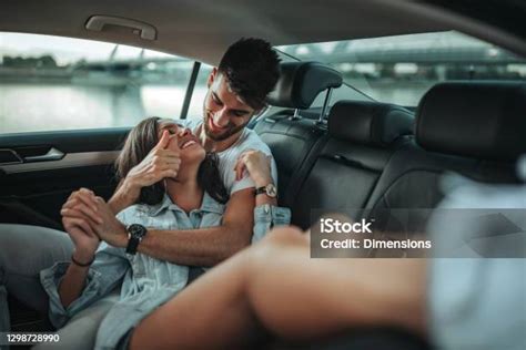 Couple Having Fun In The Backseat Stock Photo Download Image Now