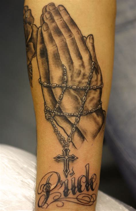 For catholics, the praying hands often have a rosary in them that is trailing over one or both of the hands. Rosary beads and praying hands Tattoo - a photo on Flickriver