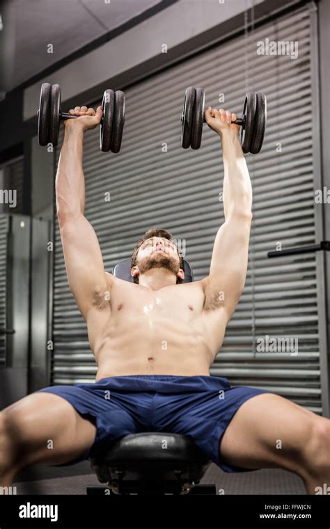 Shirtless Man Lifting Heavy Dumbbells On Bench Stock Photo Alamy