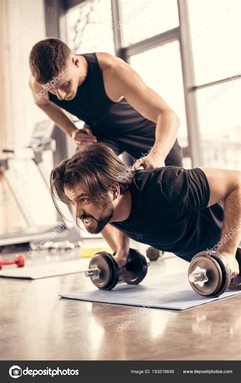 Trainer Pushing Sportsman Doing Push Ups Dumbbells Gym Stock Photo By