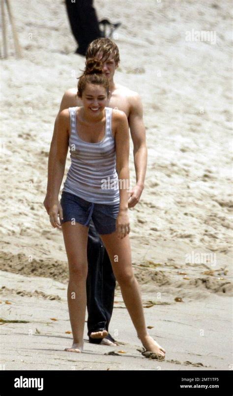 miley cyrus frolics in the surf with friends castmates while filming her latest hannah montana