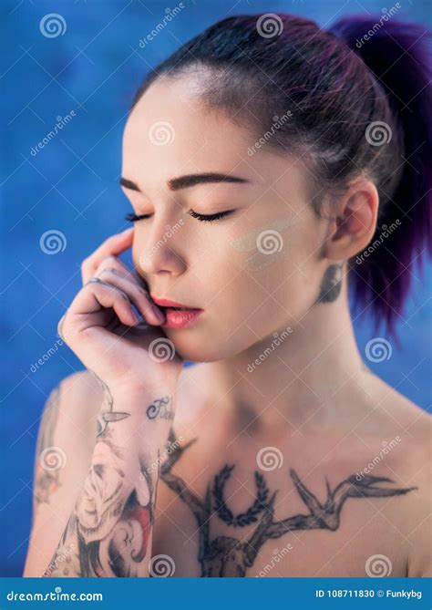 Beautiful Girl With Dyed Hair And Tattooes Posing In Studio Stock Photo