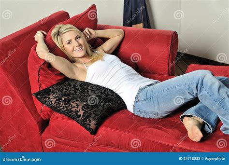 Blonde Woman Relaxing On Red Couch Stock Image Image Of Cute Longue 24718583