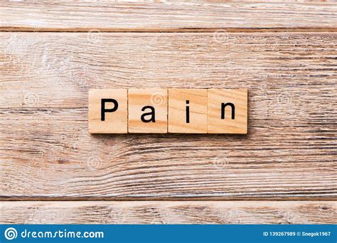 Pain Word Written On Wood Block Pain Text On Wooden Table For Your