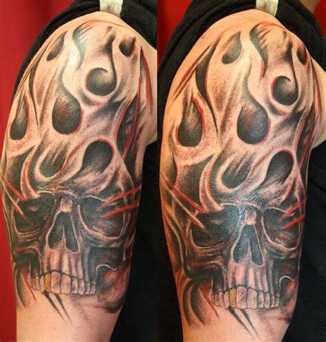 A Man S Arm With A Skull And Flames Tattoo Design On The Left Sleeve