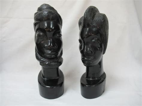 afrique lot de deux sculptures en ébène figurant un visage féminin et un visage masculin h 30 cm
