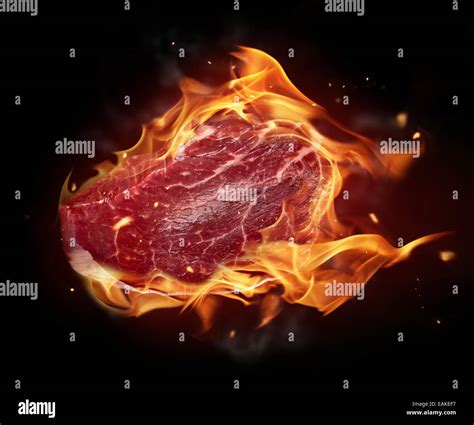 Concept Of Burning Raw Beef Steak Isolated On Black Background Stock