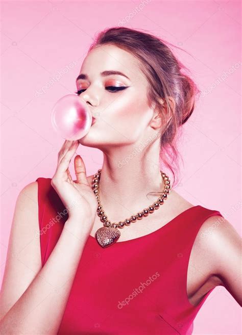 Young Woman Blowing Bubble Gum Stock Photo By ©